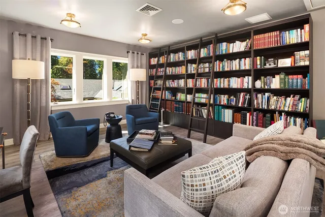 a living room with furniture and a book shelf