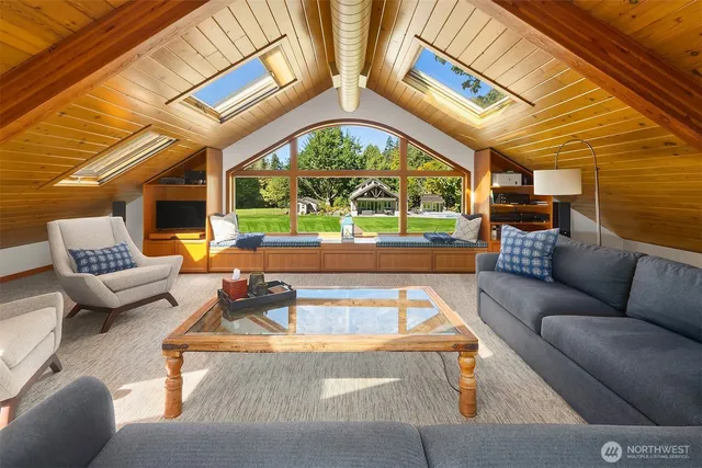 a living room with patio furniture and a large window