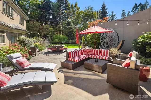 an outdoor living room with furniture and a potted plant