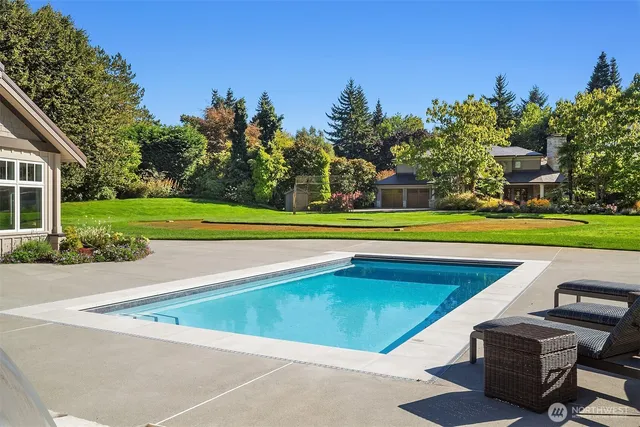 a view of a swimming pool with a yard
