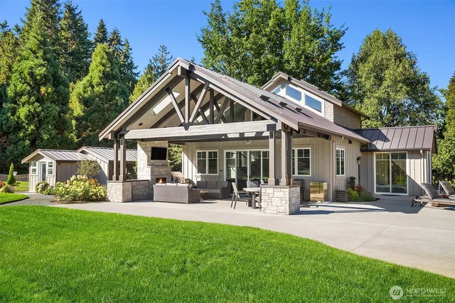 a patio with a table and chairs under an umbrella
