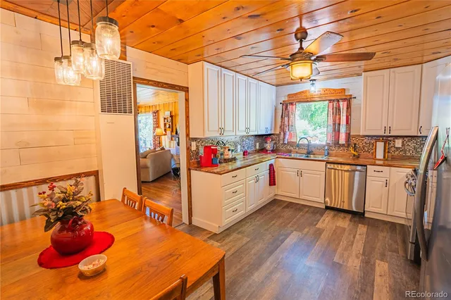 a large white kitchen with sink and cabinets