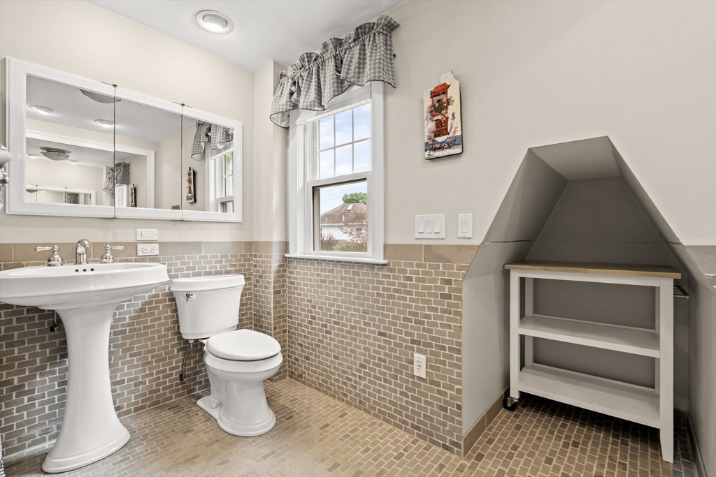15 Grace Road Medford, MA 02155 - Photo 30 of 41 a bathroom with a toilet sink and mirror
