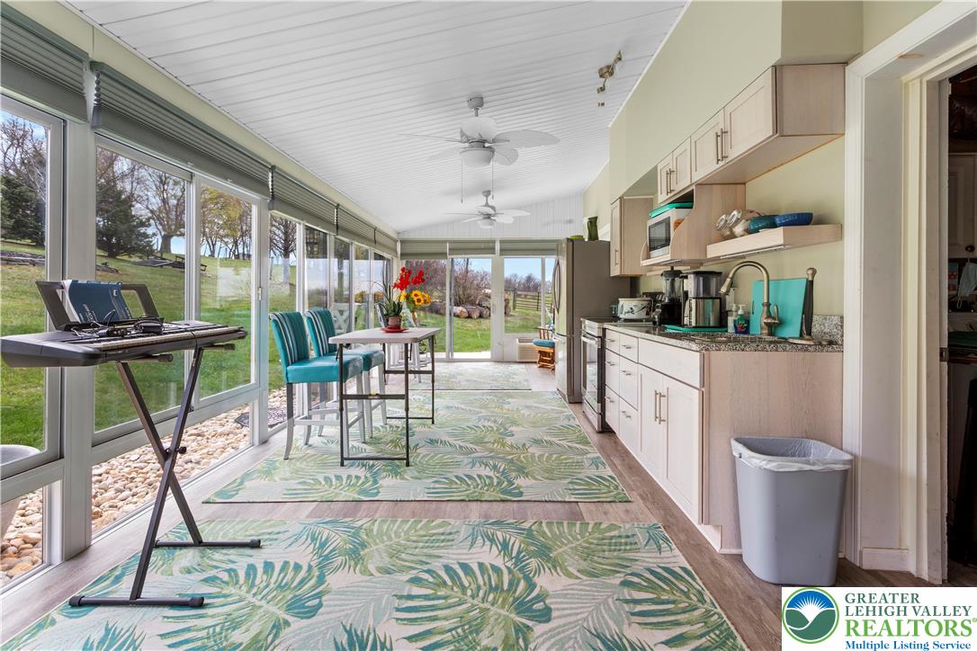 910 Gall Road Easton, PA 18040 - Photo 19 of 30 a view of a dining room with furniture a rug and a large window