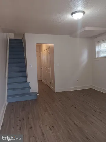 wooden floor in an empty room with a gallery