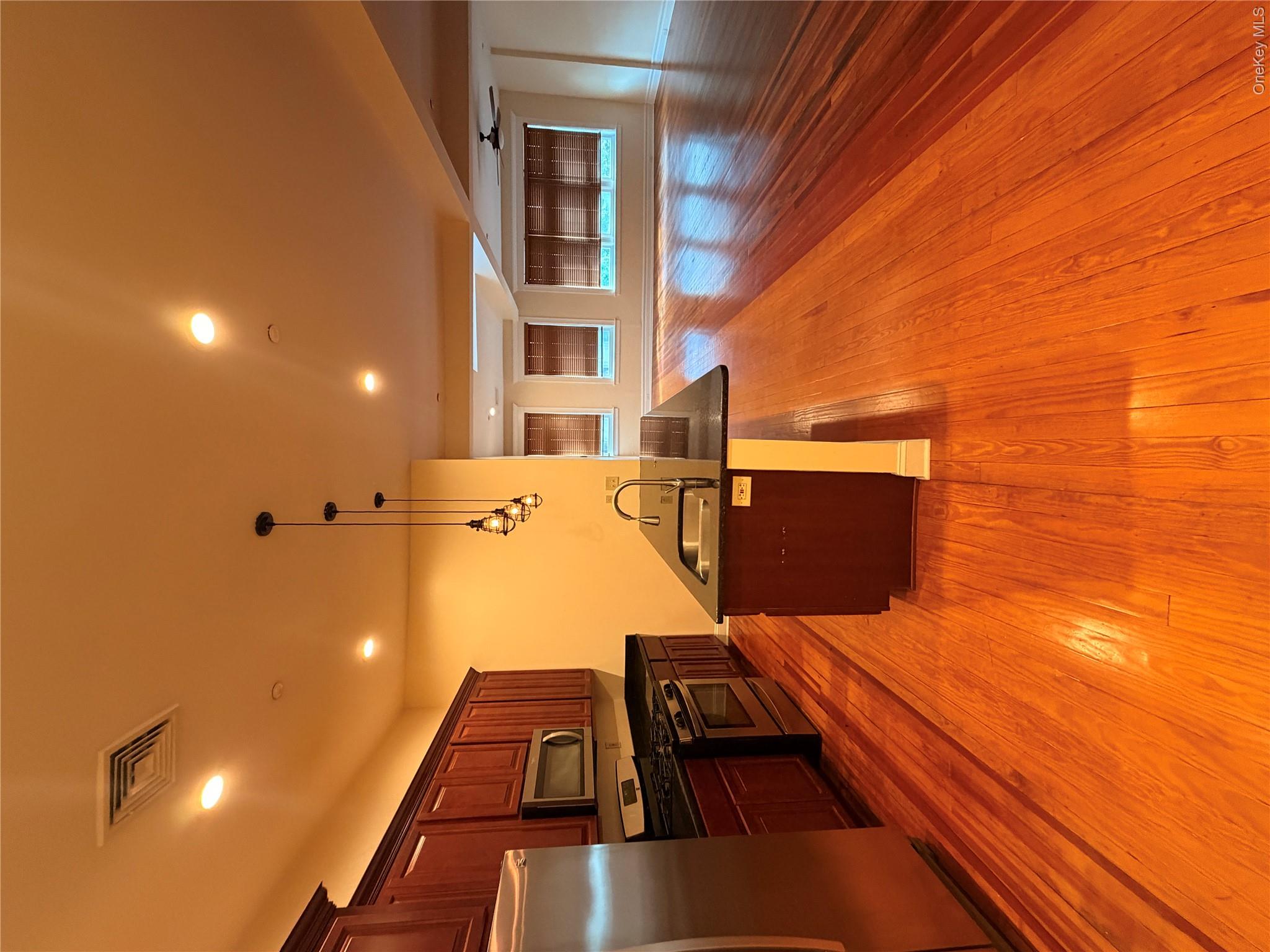 337 Main Street, Unit 3F Poughkeepsie, NY 12601 - Photo 2 of 9 a living room with stainless steel appliances furniture and a kitchen view