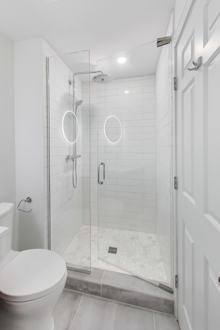 1036 West Monroe Street Chicago, IL 60607 - Photo 18 of 24 a bathroom with a shower and a toilet