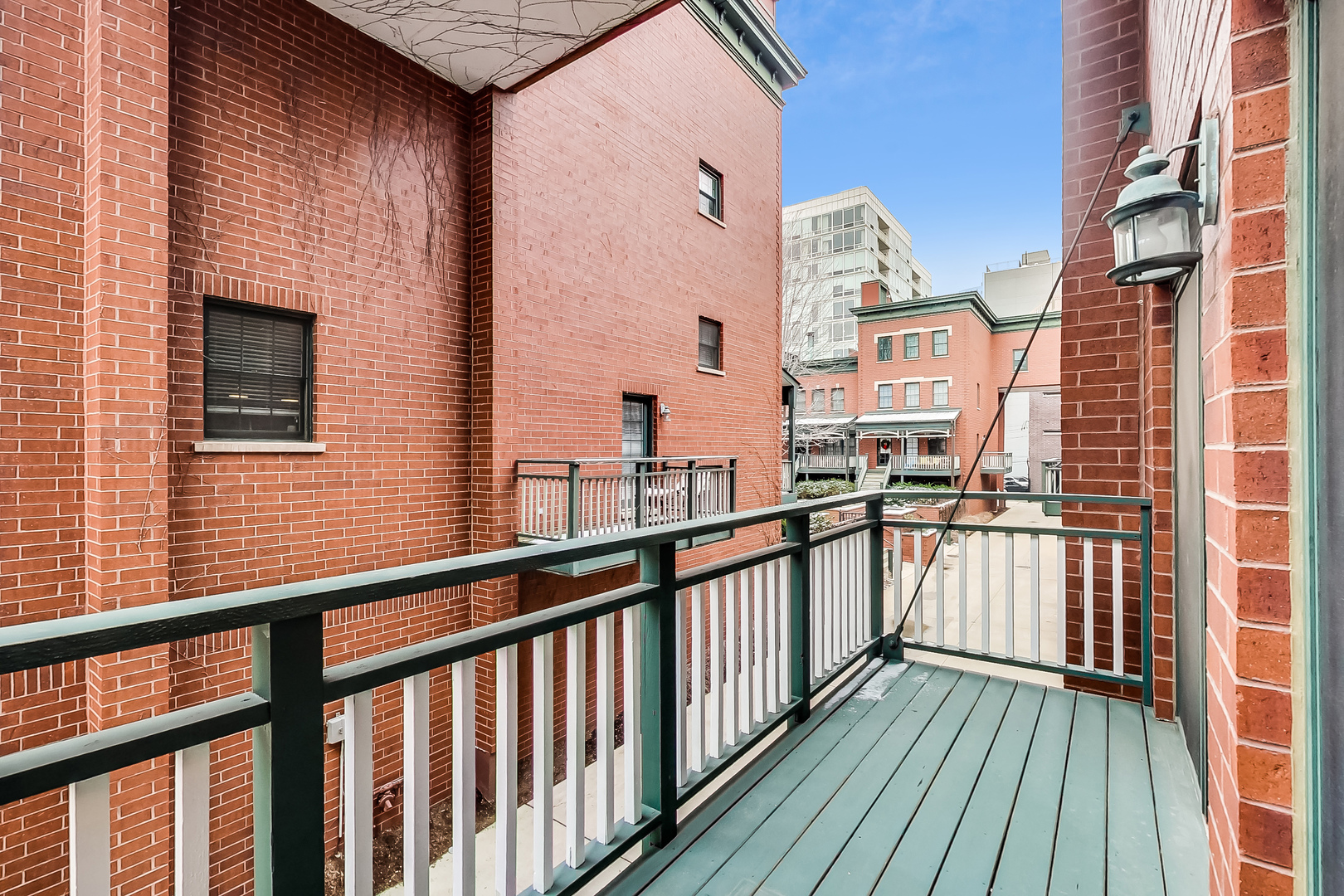 1036 West Monroe Street Chicago, IL 60607 - Photo 20 of 24 a view of balcony with wooden floor and fence