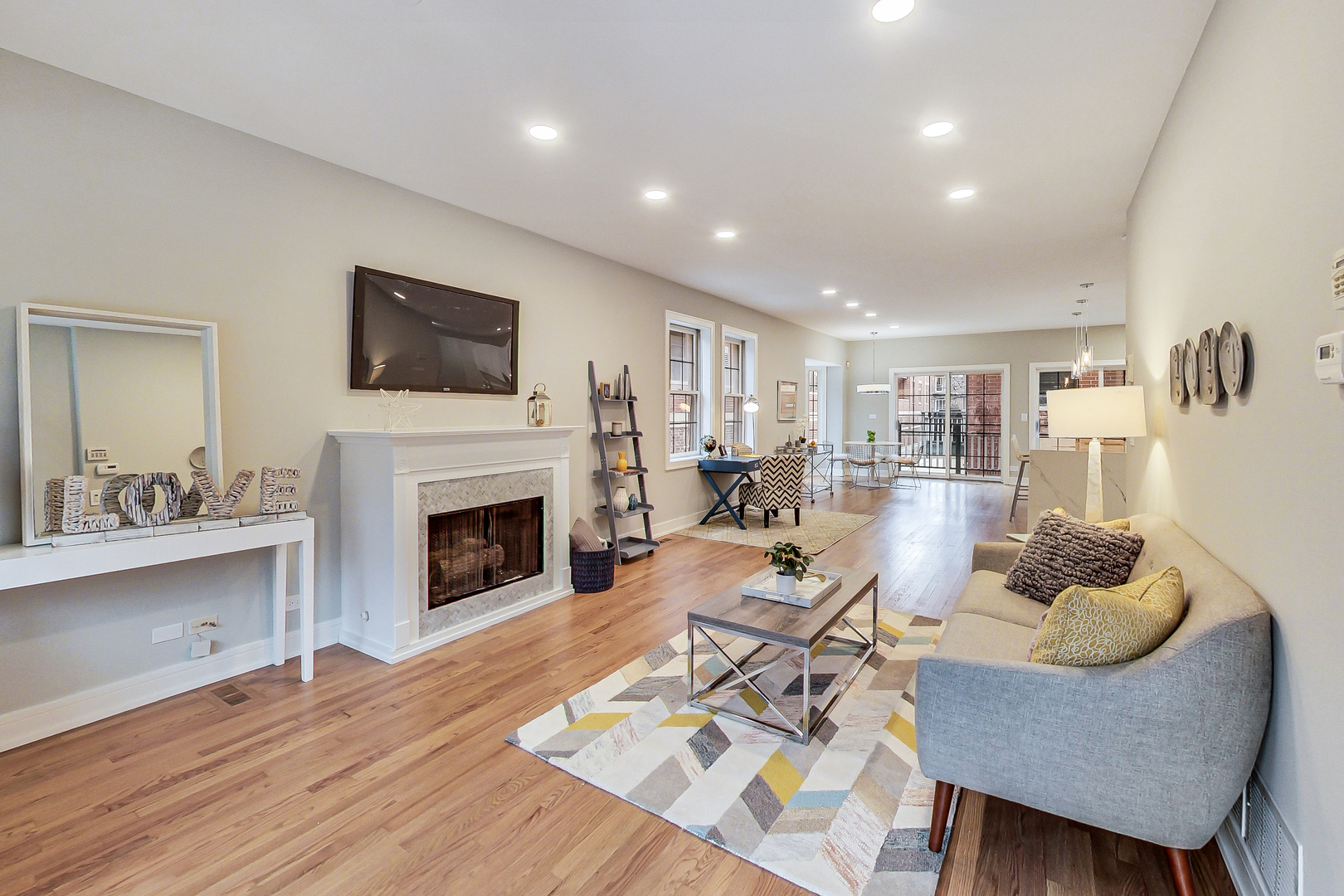 1036 West Monroe Street Chicago, IL 60607 - Photo 3 of 24 a living room with furniture a fireplace and a flat screen tv