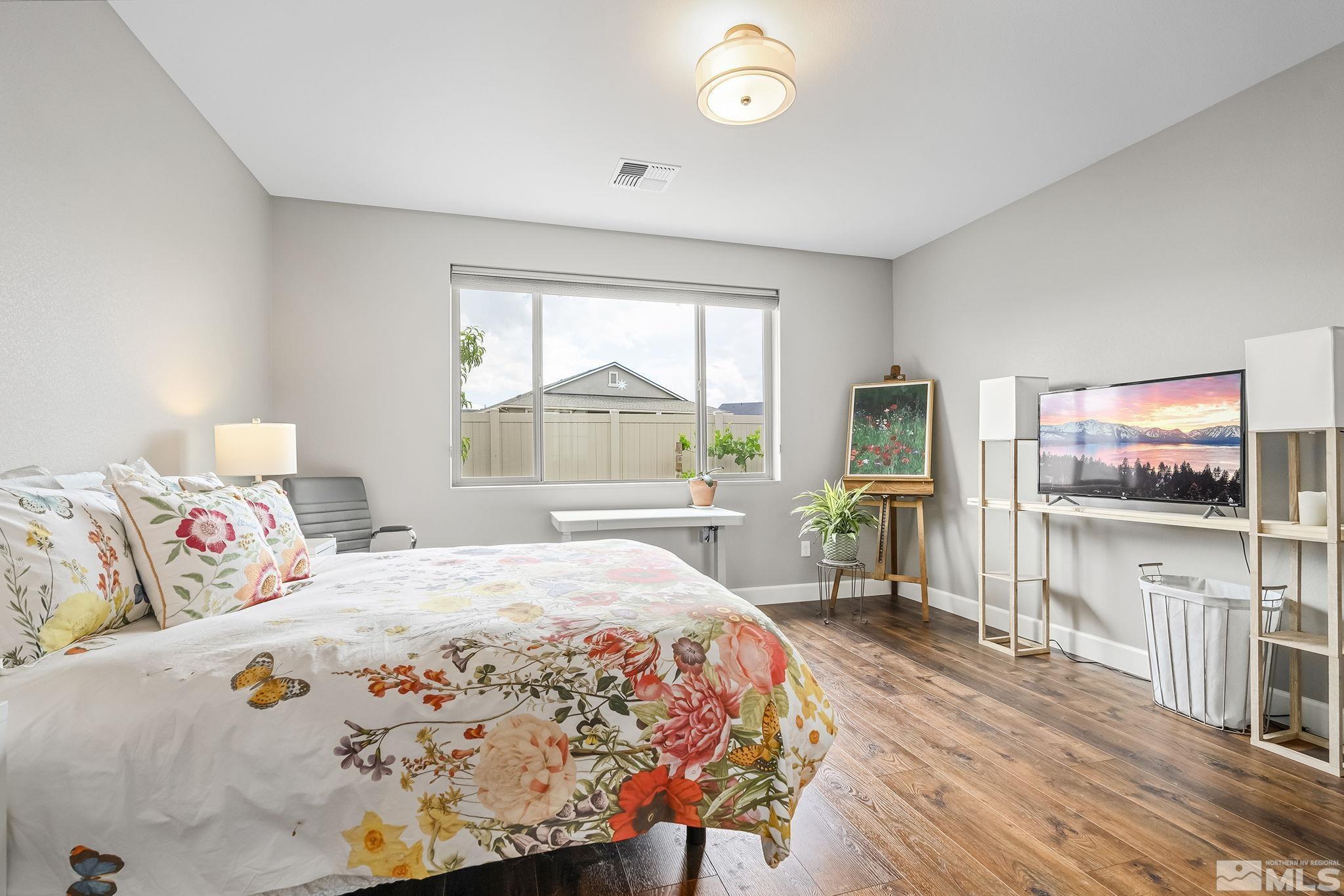 626 Riverbed Circle Reno, NV 89521 - Photo 13 of 27 a bedroom with a bed and a flat screen tv