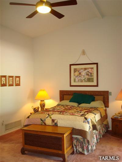 9985 North Desert Sky Road Oro Valley, AZ 85737 - Photo 24 of 43 a bedroom with a bed and a lamp on dresser