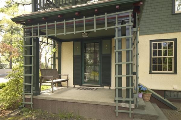74 Larch Road Cambridge, MA 02138 - Photo 3 of 12 a front view of a house with a glass windows and table
