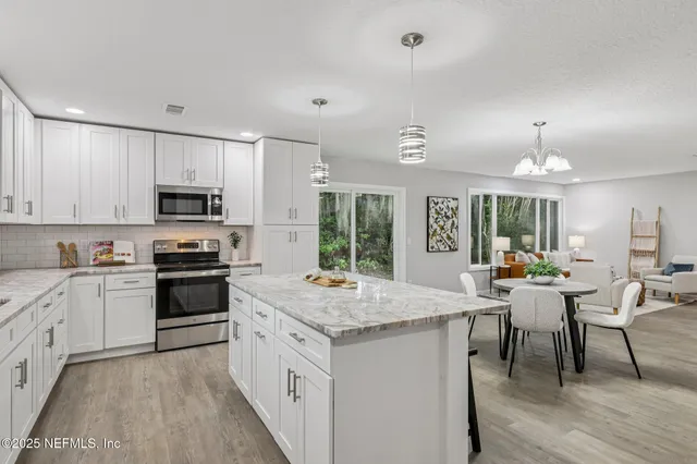 a kitchen with a table chairs refrigerator and cabinets