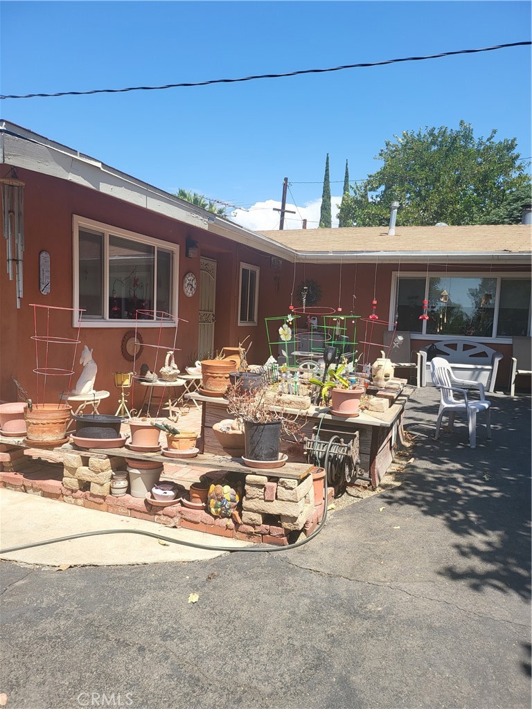 18890 Gentian Avenue Riverside, CA 92508 - Photo 1 of 1 a view of a patio with table and chairs under an umbrella