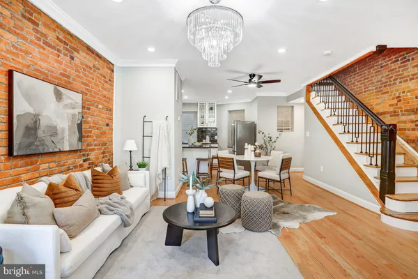 a living room with furniture and a chandelier
