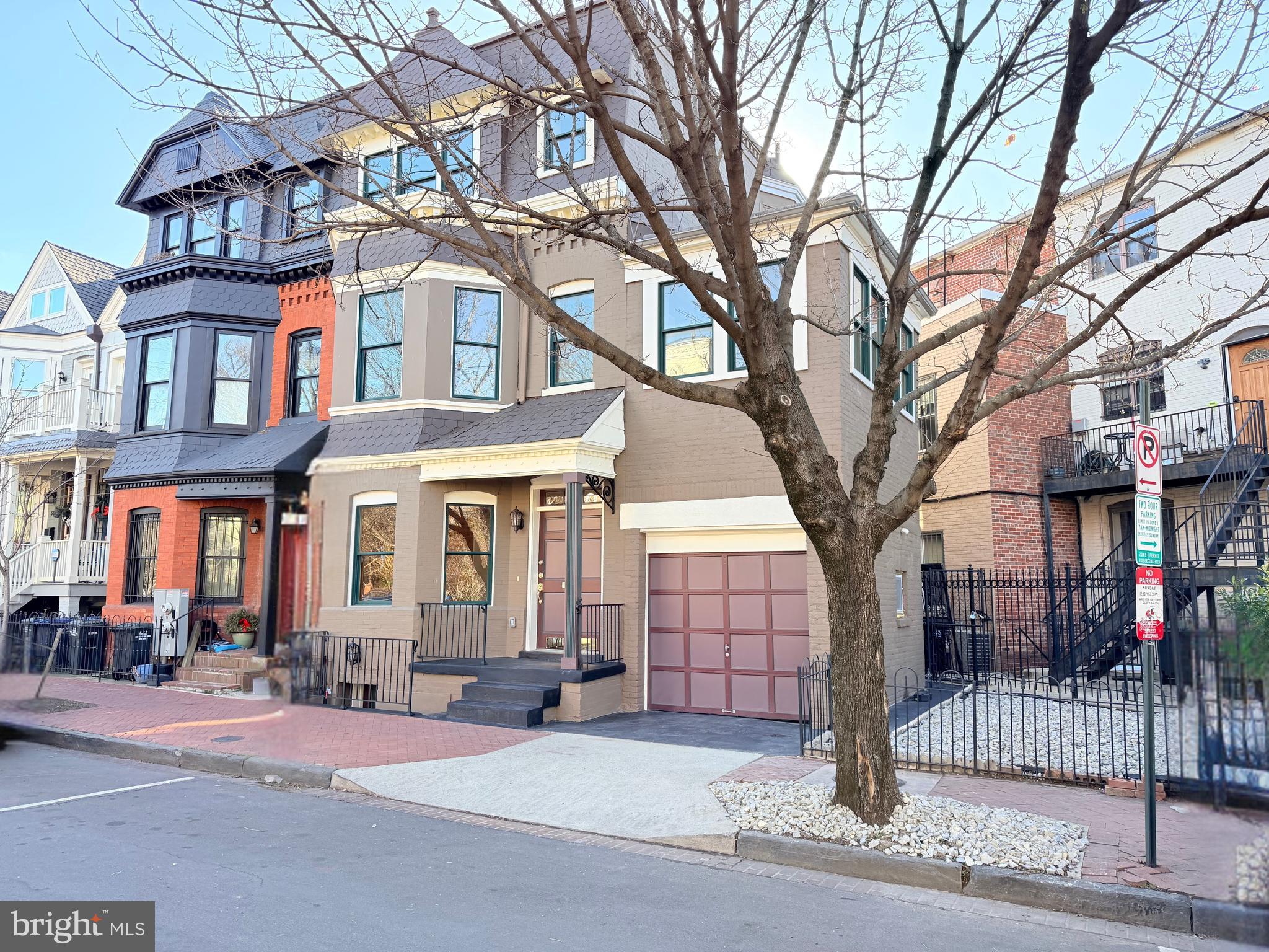 524 T Street Northwest Washington, DC 20001 - Photo 6 of 54 a front view of a building with large trees and a barn