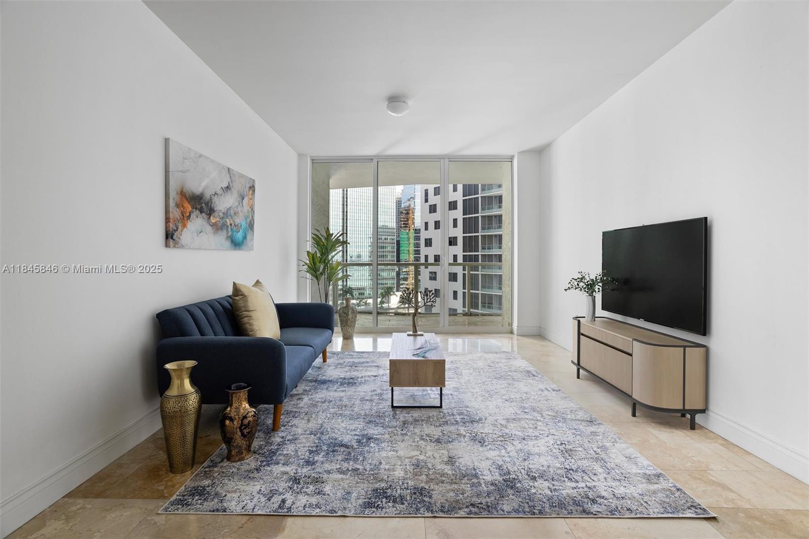218 Southeast 14th Street, Unit 1904 Miami, FL 33131 - Photo 3 of 28 a living room with furniture and a flat screen tv