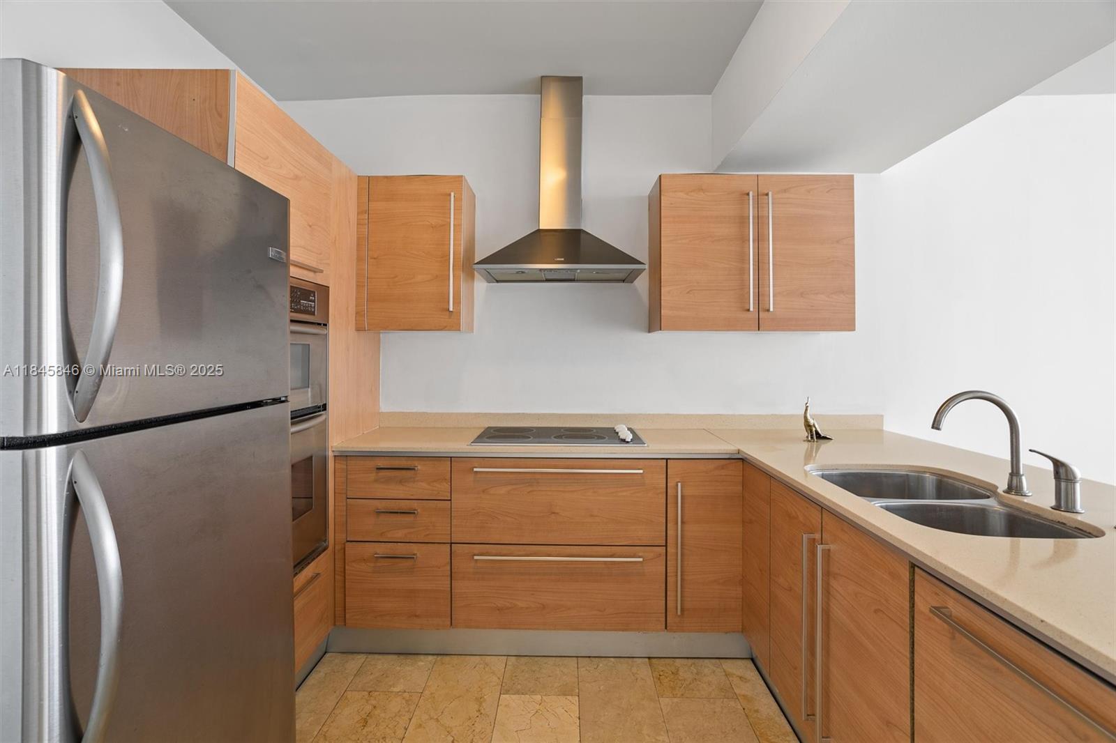 218 Southeast 14th Street, Unit 1904 Miami, FL 33131 - Photo 8 of 28 a kitchen with stainless steel appliances granite countertop a refrigerator sink and stove