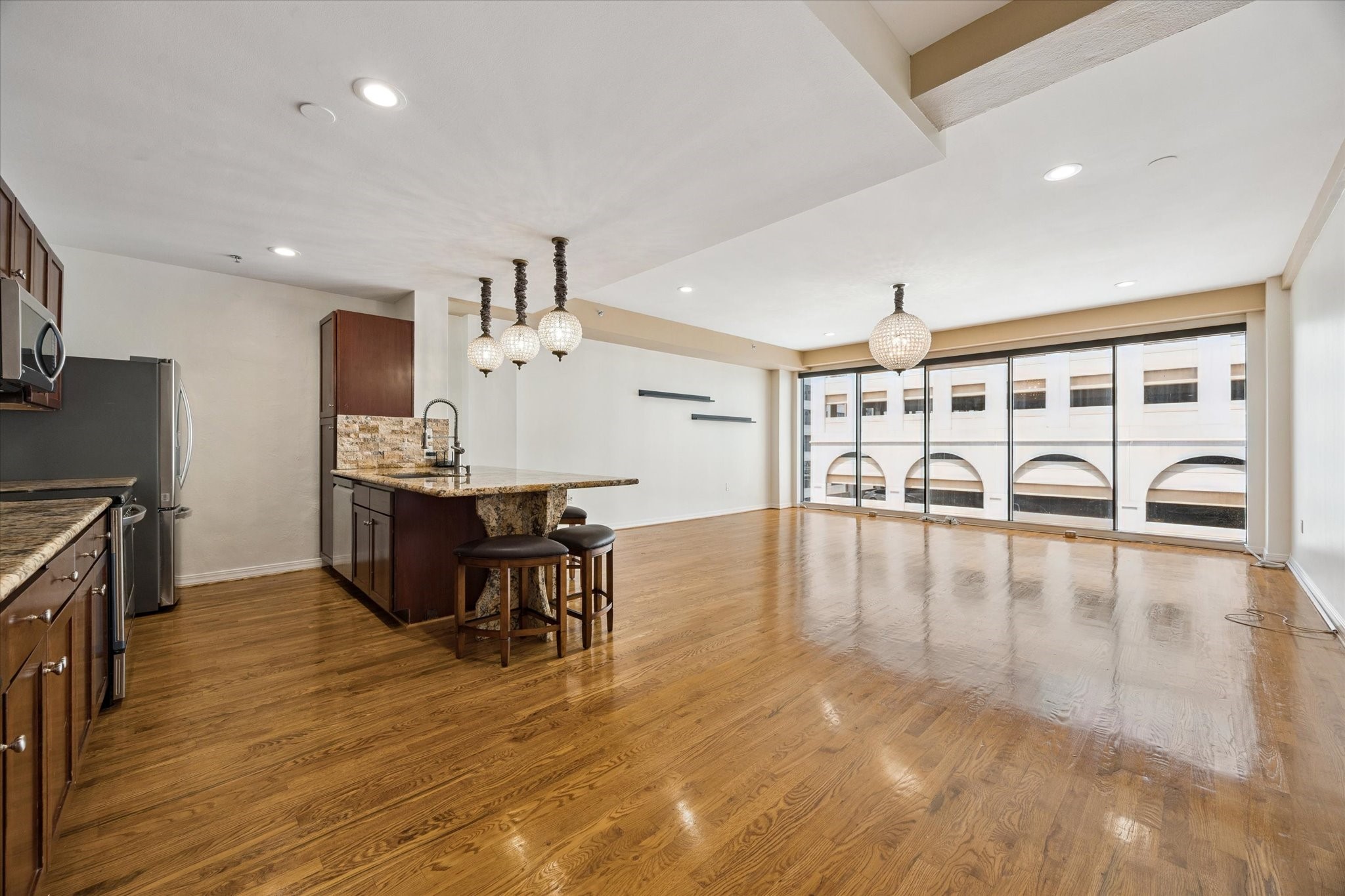 917 Main Street, Unit 1005 Houston, TX 77002 - Photo 2 of 14 a view of a dining room with furniture and wooden floor