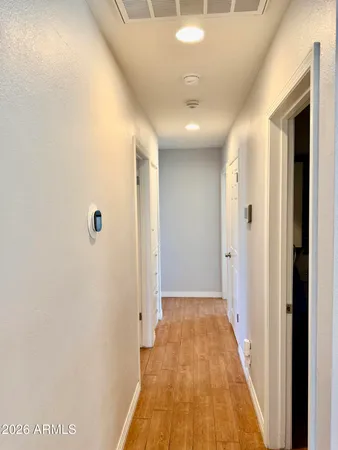 a view of a hallway with wooden floor