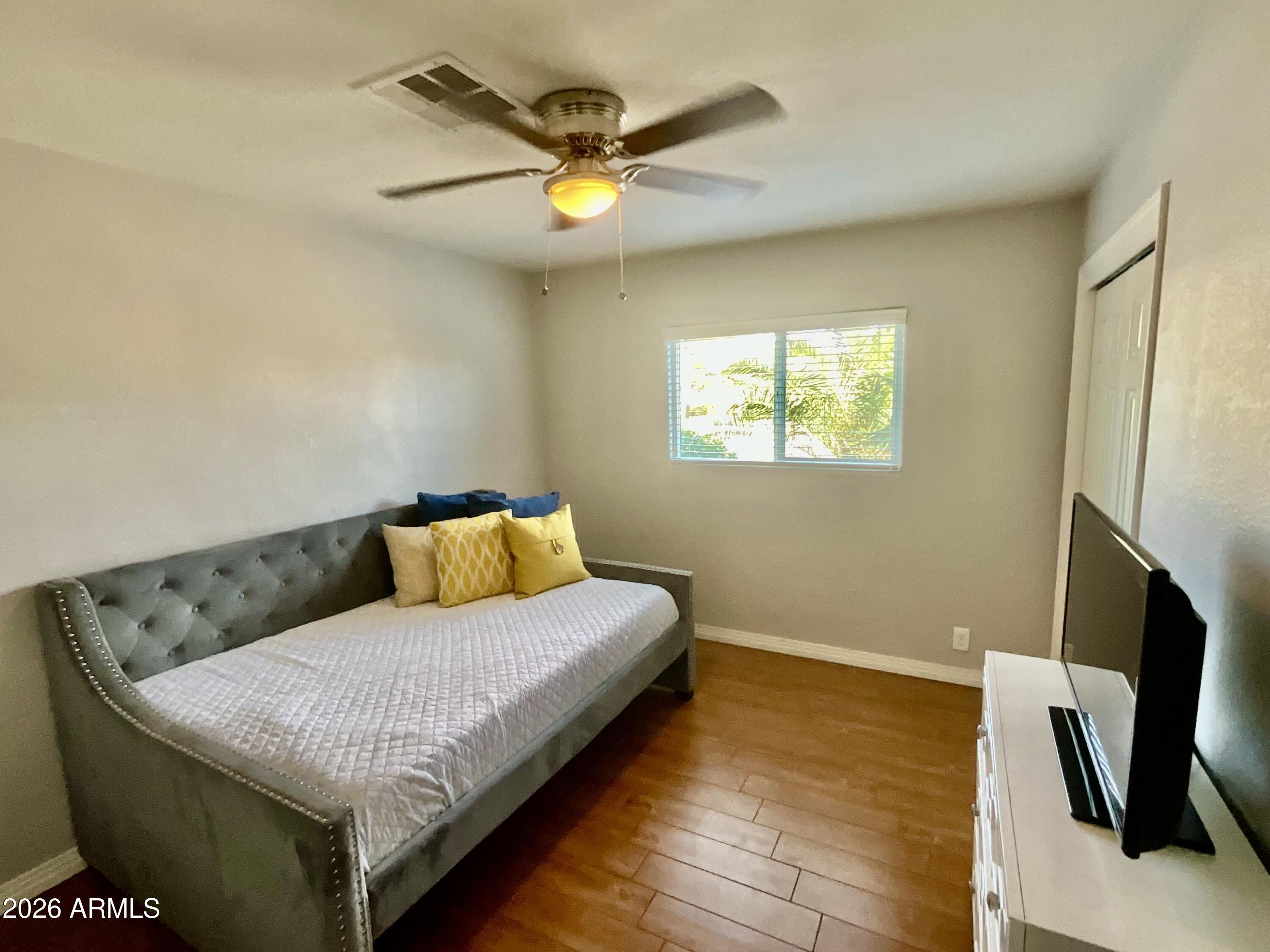 1601 West Lamar Road Phoenix, AZ 85015 - Photo 13 of 28 a living room with a bed furniture and a flat screen tv