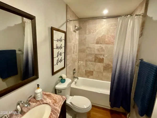 a bathroom with a bathtub toilet and shower