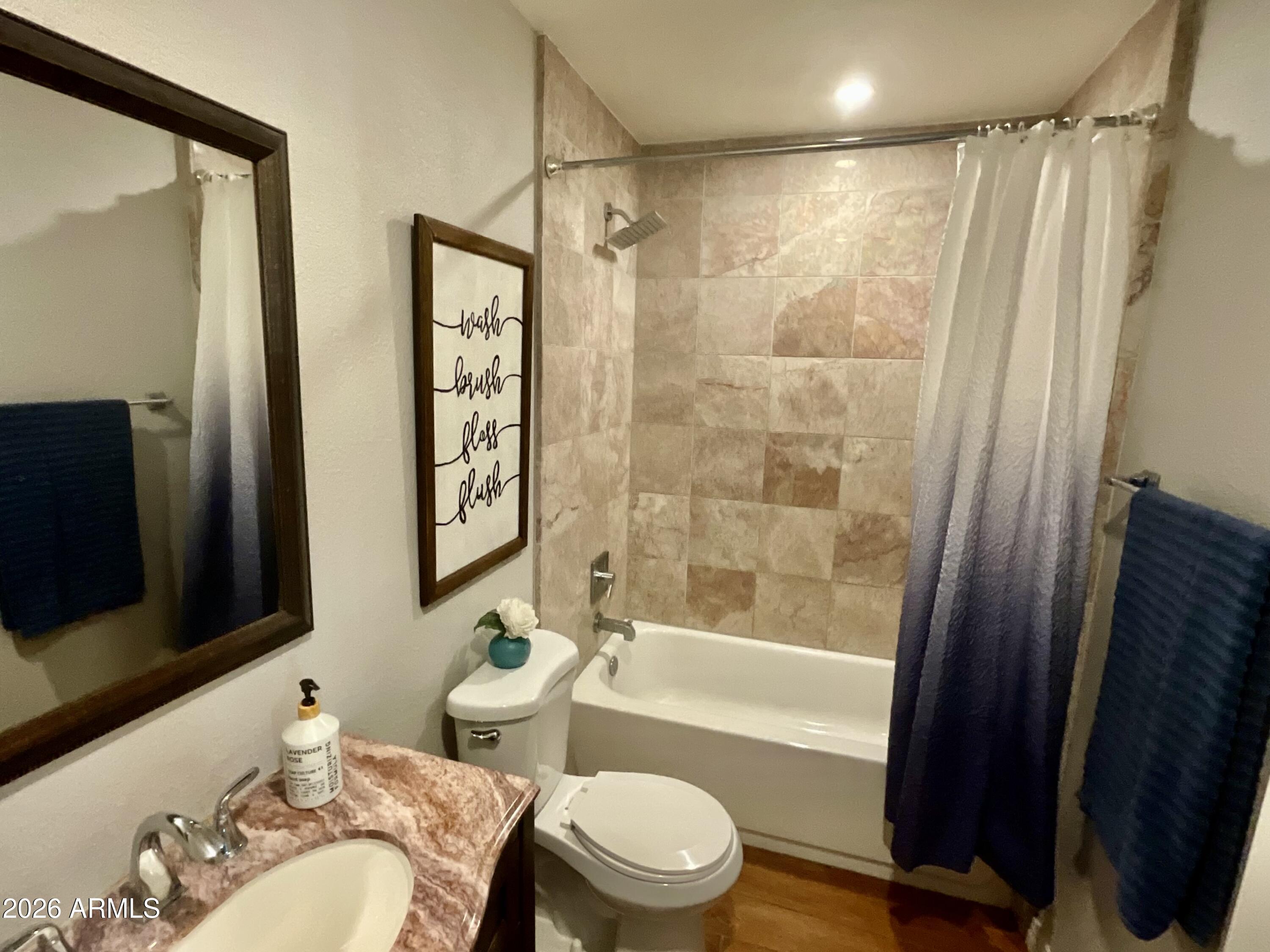1601 West Lamar Road Phoenix, AZ 85015 - Photo 15 of 28 a bathroom with a bathtub toilet and shower