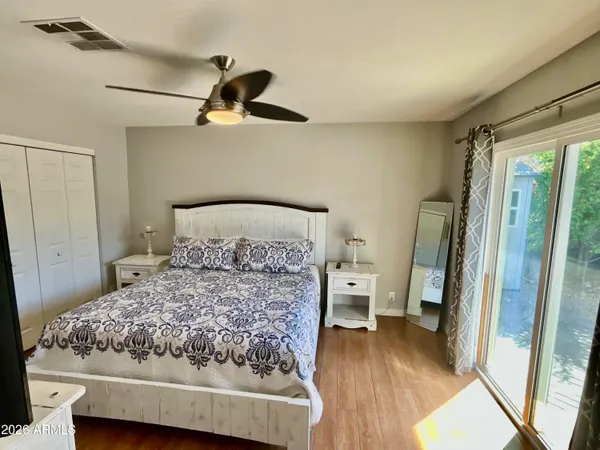 a bedroom with a bed and wooden floor