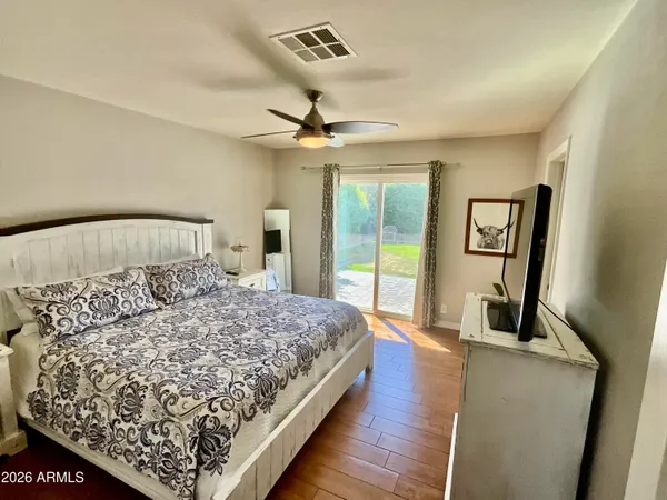 a bedroom with a large bed and a chandelier