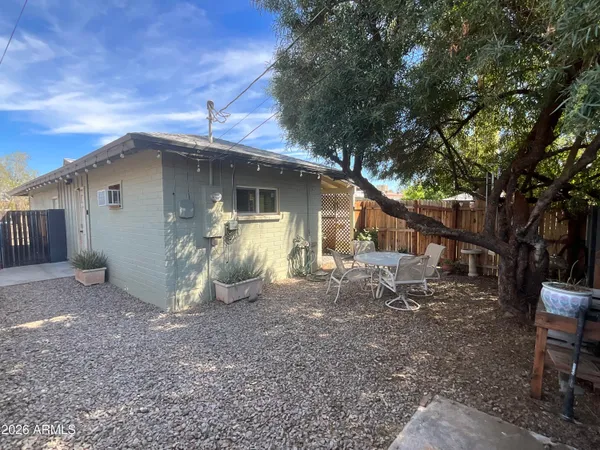 a view of a small house with a yard
