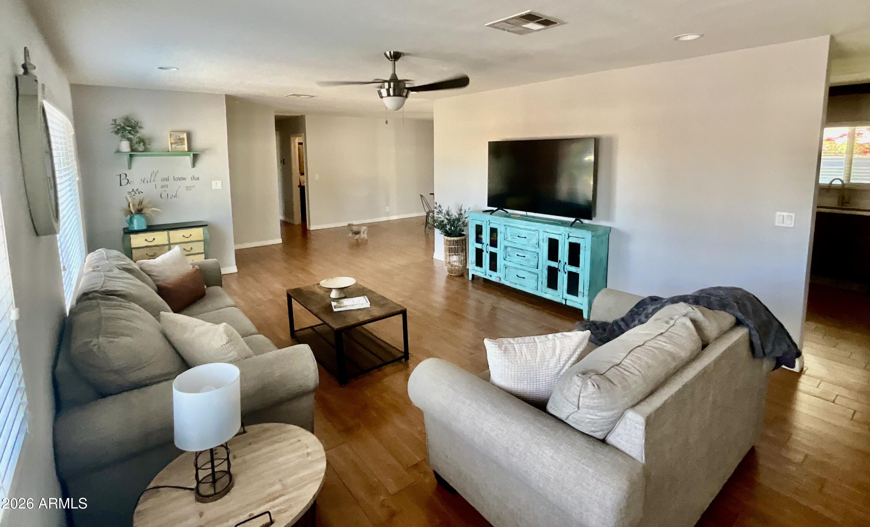1601 West Lamar Road Phoenix, AZ 85015 - Photo 6 of 28 a living room with furniture and a flat screen tv