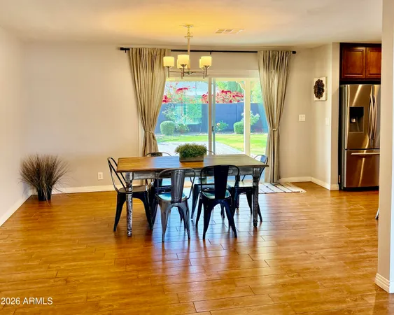 a view of a dining room with furniture and a floor to ceiling window