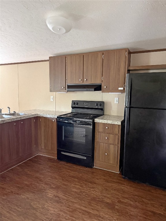 390 Hidden Oaks Drive Point Blank, TX 77364 - Photo 4 of 7 a kitchen with a refrigerator stove and wooden cabinets