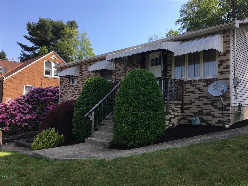 741 Wolf Avenue Rochester, PA 15074 - Photo 1 of 22 a front view of a house with a garden