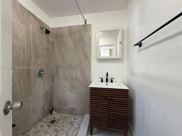 a bathroom with a sink a toilet and a shower