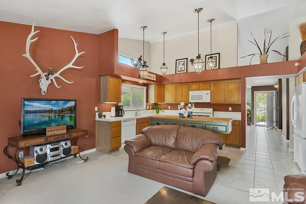 5471 Morning Star Drive Reno, NV 89523 - Photo 7 of 22 a living room with furniture a flat screen tv and kitchen view