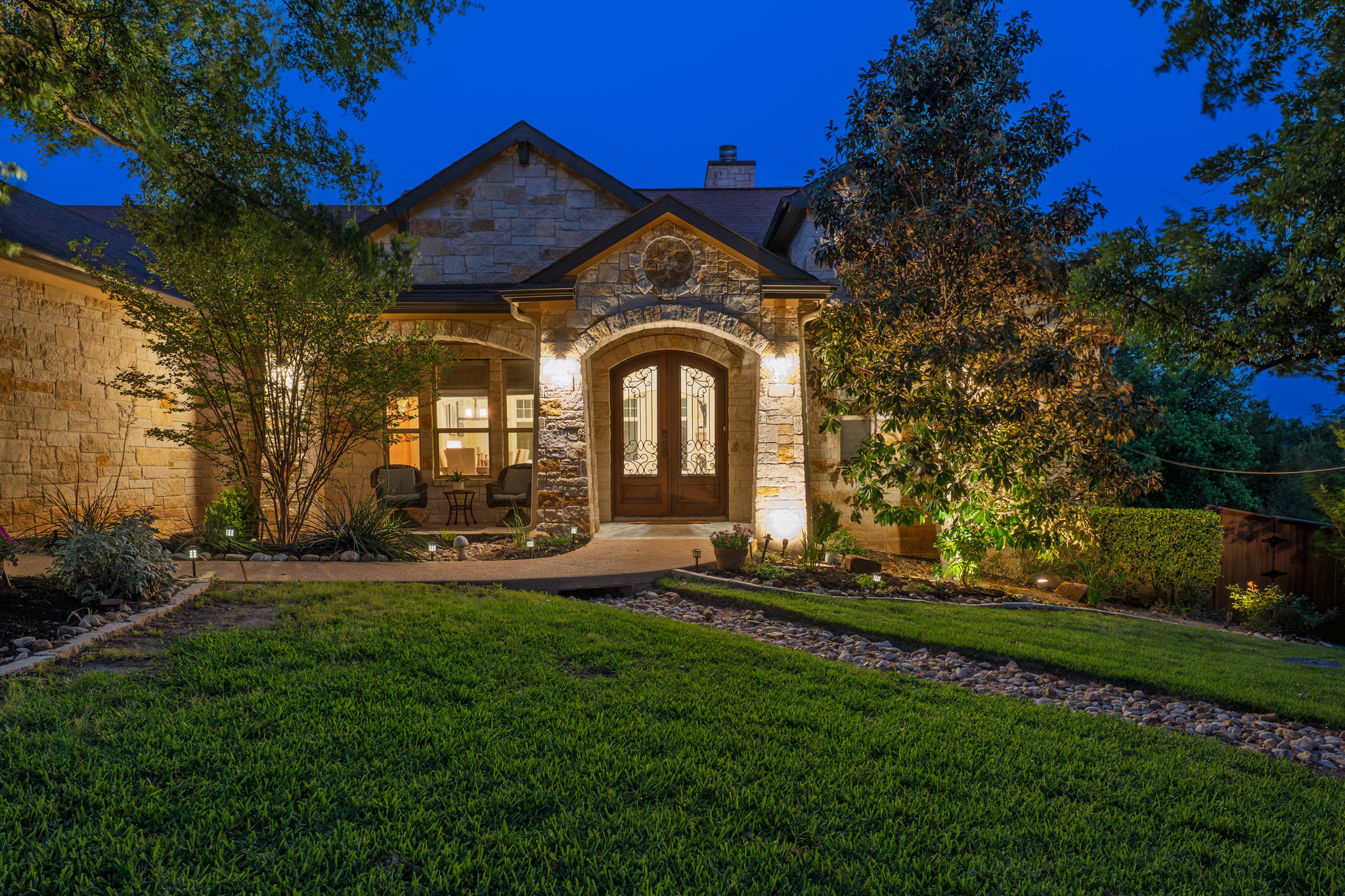 a front view of a house with a garden