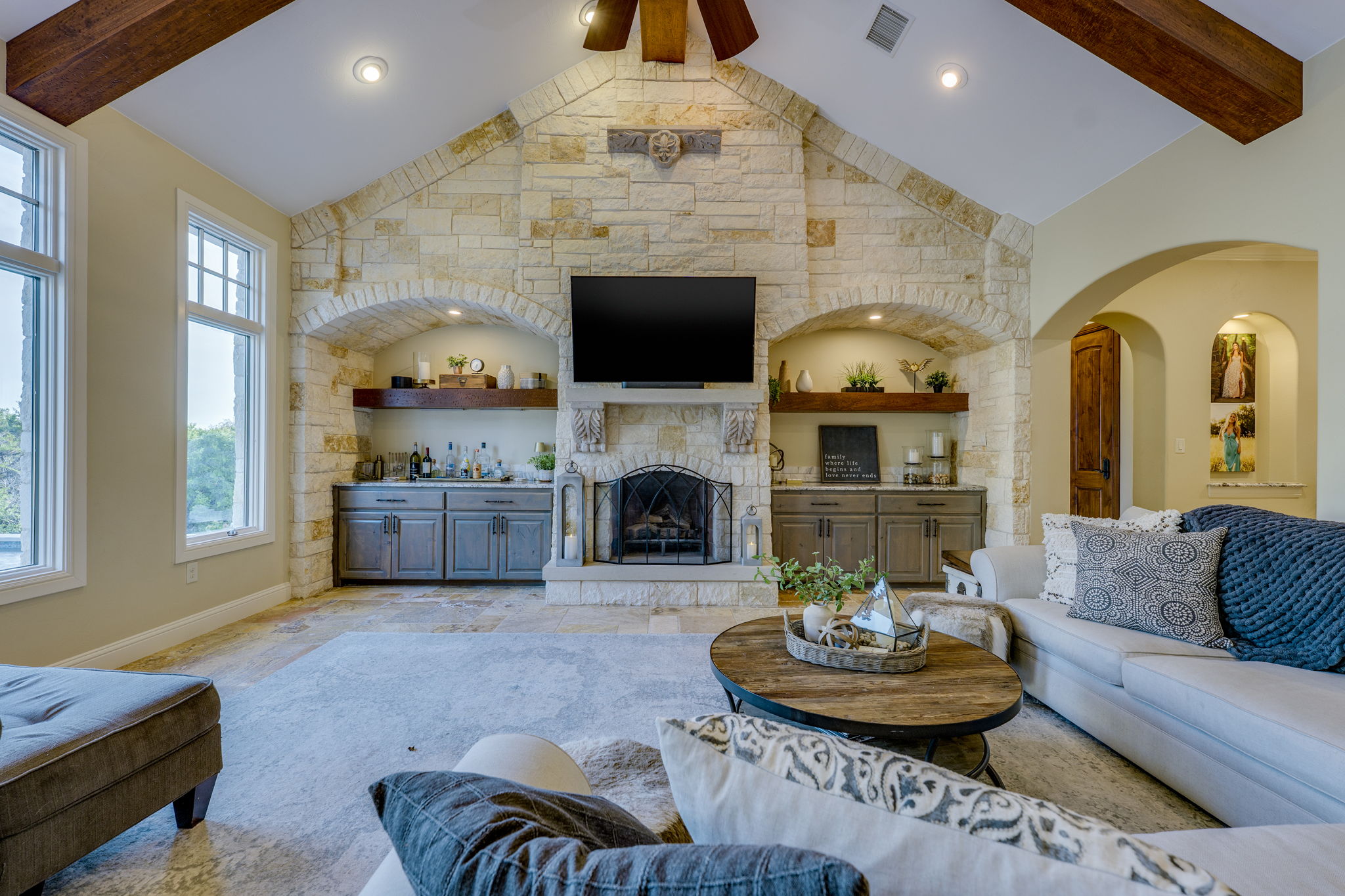 2703 Pyramid Drive Austin, TX 78734 - Photo 13 of 37 a living room with furniture a fireplace and a flat screen tv
