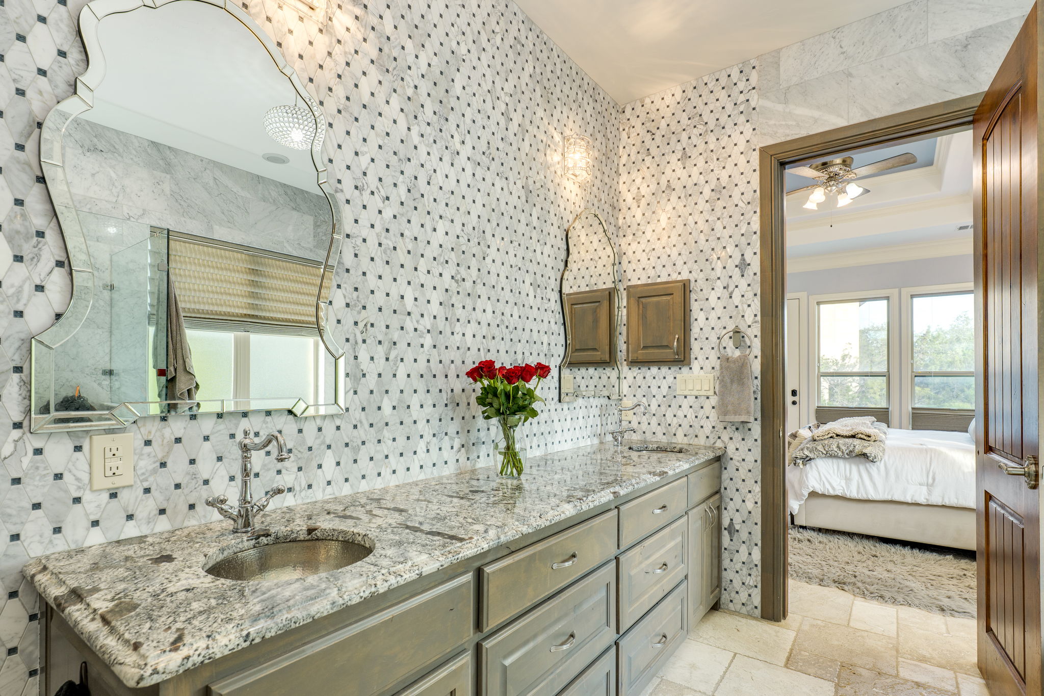 2703 Pyramid Drive Austin, TX 78734 - Photo 24 of 37 a bathroom with a granite countertop sink and a mirror