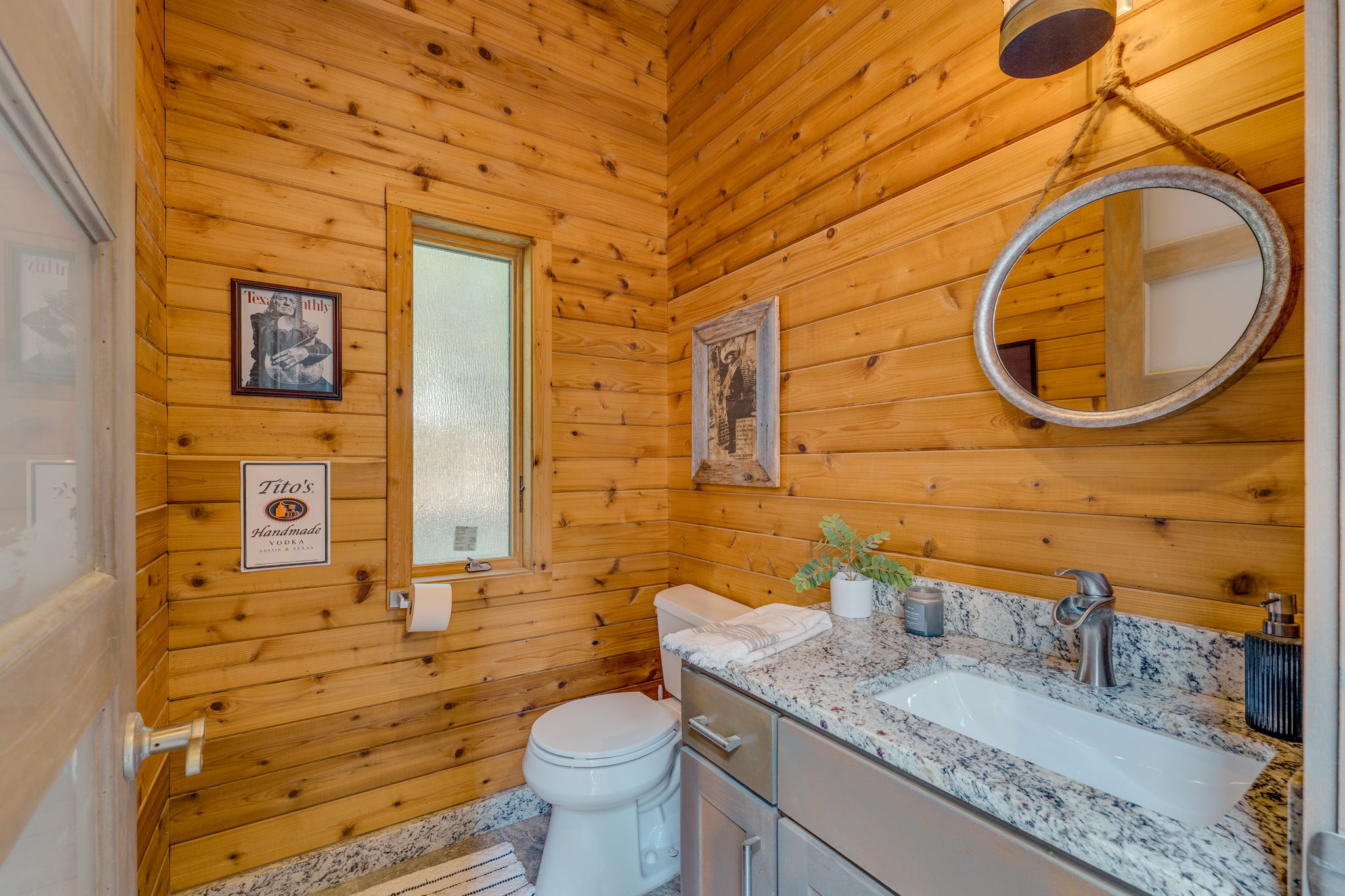 2703 Pyramid Drive Austin, TX 78734 - Photo 32 of 37 a bathroom with a granite countertop toilet sink and mirror