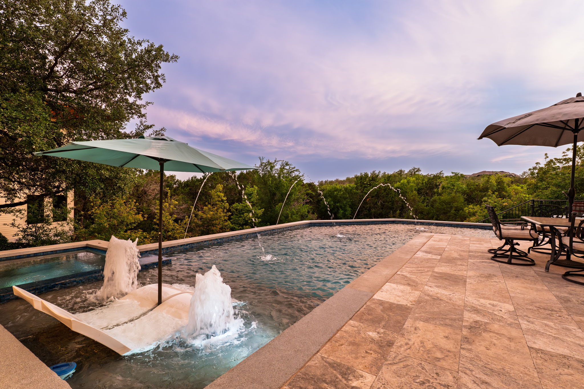 2703 Pyramid Drive Austin, TX 78734 - Photo 37 of 37 a view of a swimming pool with lawn chairs under an umbrella