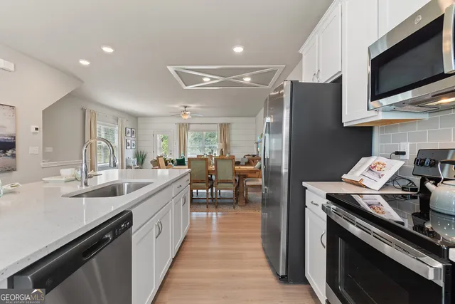 a kitchen with stainless steel appliances granite countertop a sink and a stove