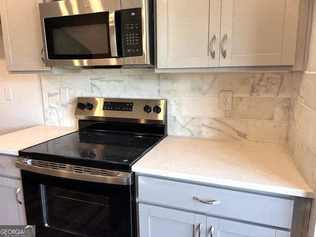 a kitchen with a stove and a microwave