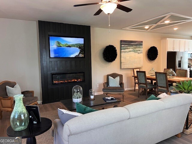 35 Cobalt Lane, Unit 81 Newnan, GA 30265 - Photo 6 of 30 a living room with furniture a flat screen tv and a fireplace