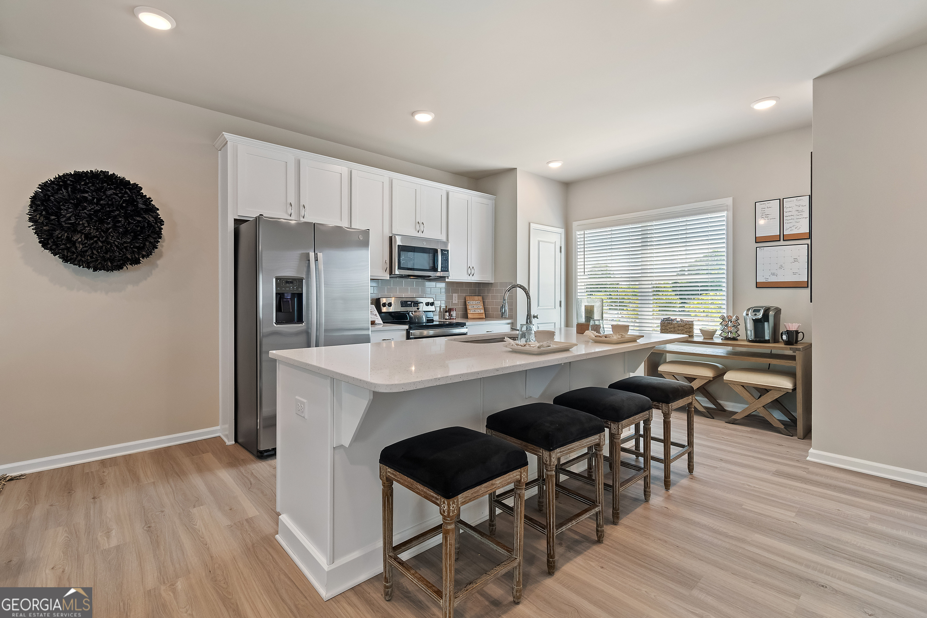 35 Cobalt Lane, Unit 81 Newnan, GA 30265 - Photo 9 of 30 a kitchen with a table chairs refrigerator and microwave