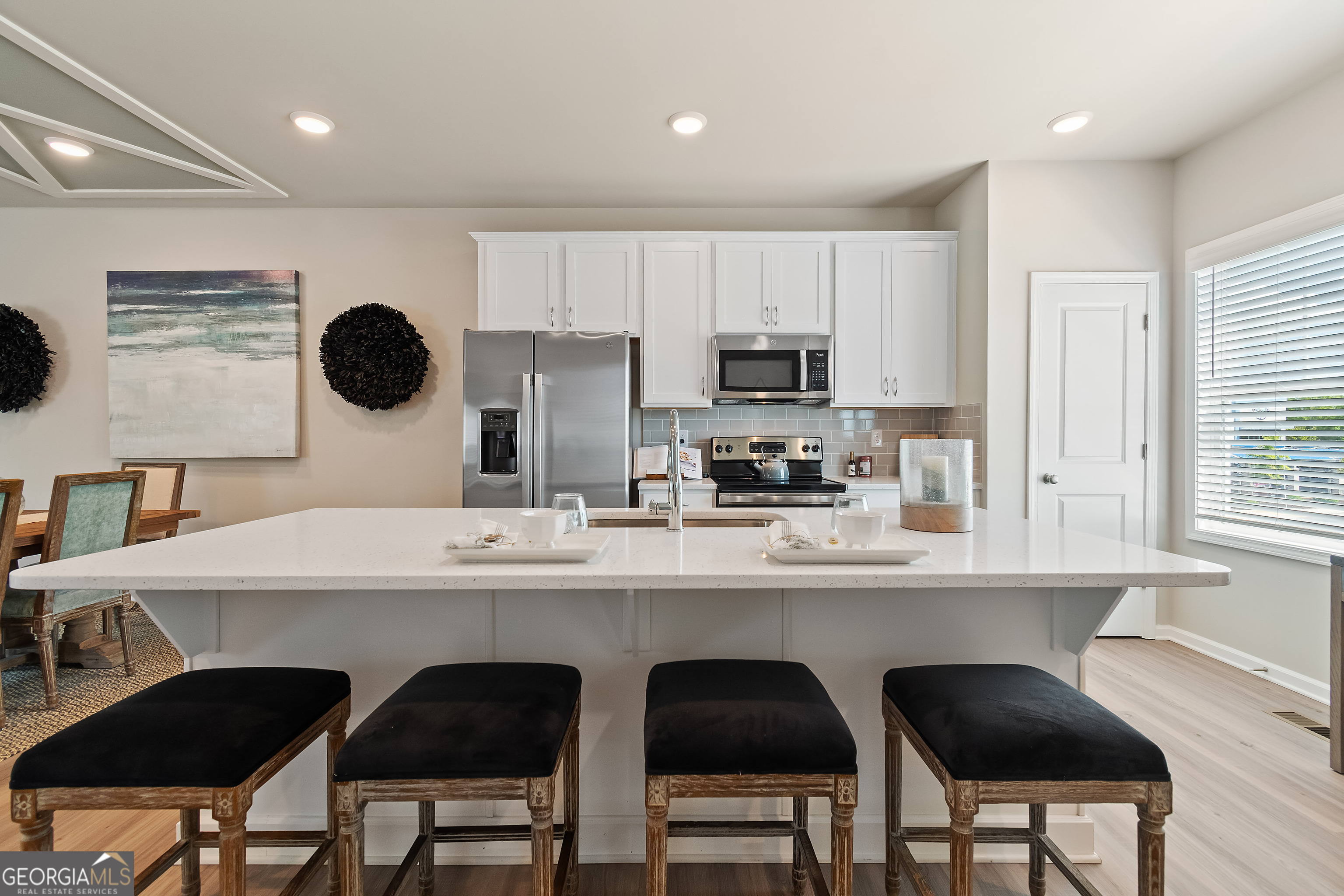 35 Cobalt Lane, Unit 81 Newnan, GA 30265 - Photo 10 of 30 a kitchen with a dining table chairs and a refrigerator