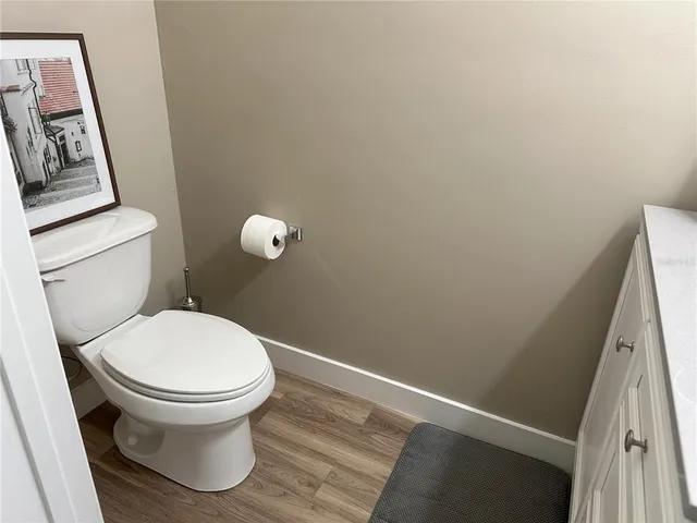 a white toilet sitting next to a shower