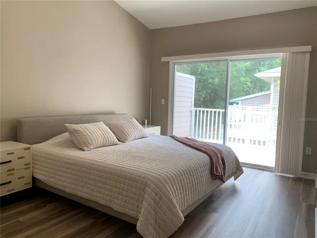 a bedroom with a bed and a large window