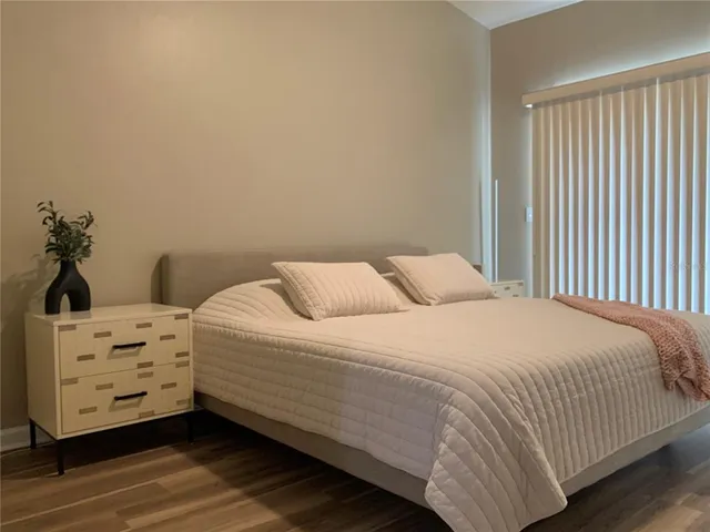 a bedroom with a bed and dresser