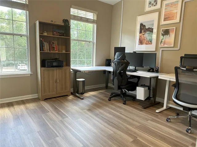 an empty room with wooden floor and closet
